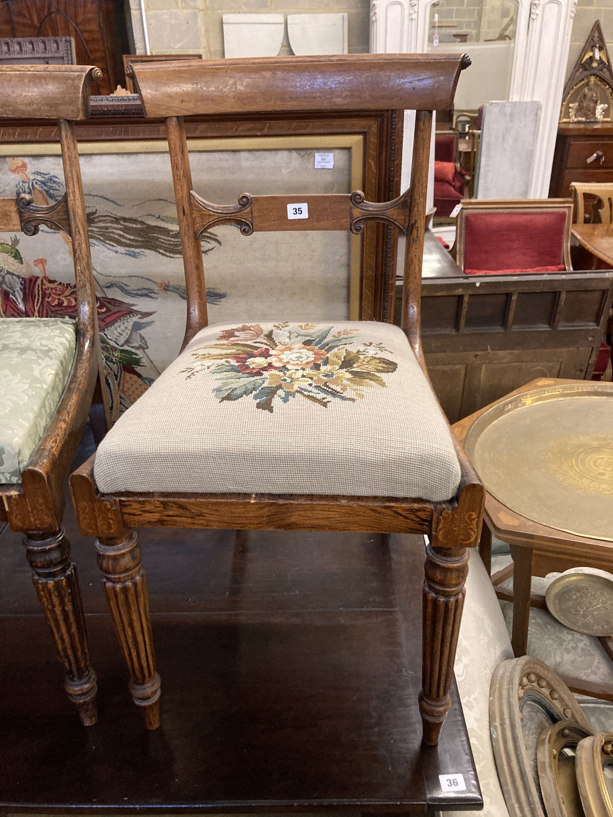 A pair of William IV simulated rosewood dining chairs, with curved marquetry inlaid crest rails and spars, over tapestry drop in seats